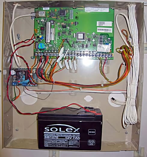 Security control panel showing large battery that needs to be replaced every 3-5 years